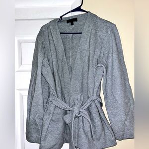 Grey, belted sweater jacket.